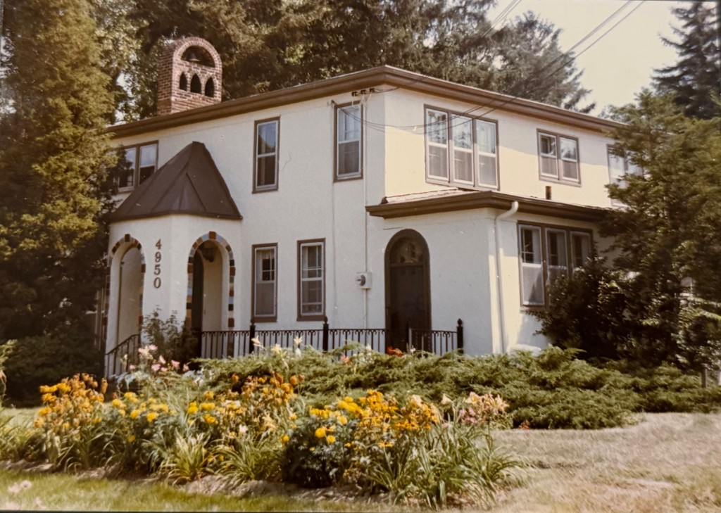 The Ministries House on Hagadorn Road — a white stucco building with a small brick bell tower and arched entrance.